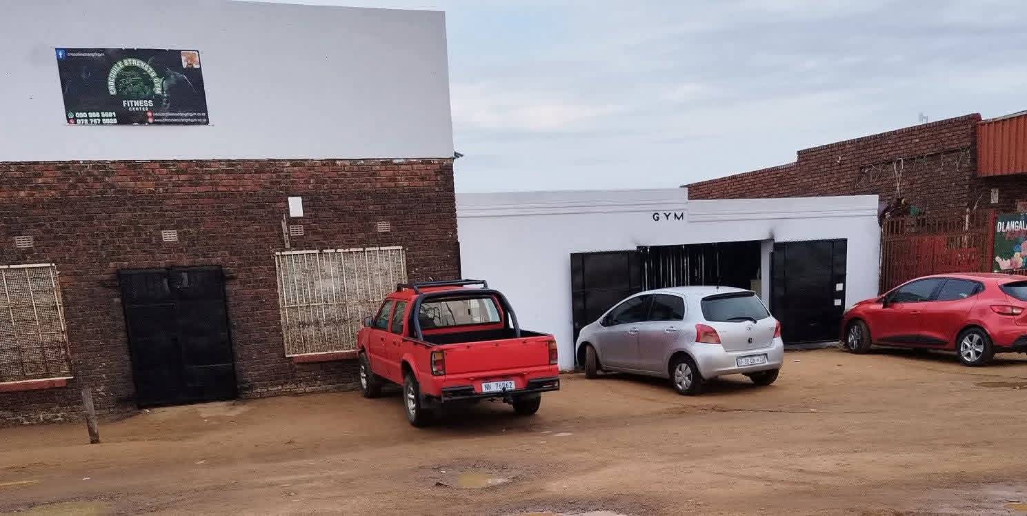 Crocodile Strength Gym entrance with door and parked vehicle